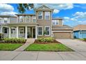 Two-story home with a welcoming porch and well-kept lawn, complemented by an attached two-car garage at 5949 Parkset Dr, Lithia, FL 33547