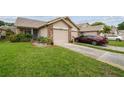 Attractive home featuring well-maintained landscaping and a two-car garage at 6529 Thicket Trl, New Port Richey, FL 34653