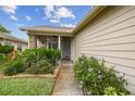 Charming home exterior with lush landscaping leading to a welcoming front door at 6529 Thicket Trl, New Port Richey, FL 34653
