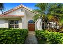 Welcoming front entrance with double doors, a pathway lined with manicured hedges, and a beautifully tiled roof at 772 Live Oak Ne Ter, St Petersburg, FL 33703