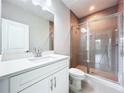 Modern bathroom with glass shower, mosaic tile, and white vanity at 7733 93Rd N St # 26, Seminole, FL 33777