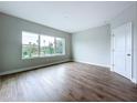 Minimalist bedroom featuring hardwood floors, a large window, and neutral paint at 7733 93Rd N St # 26, Seminole, FL 33777