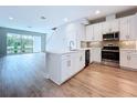 Bright kitchen featuring stainless steel appliances, white cabinets, and center island with sink at 7733 93Rd N St # 26, Seminole, FL 33777