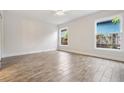 Bright, empty bedroom with wood-look floors and dual windows, offering a blank canvas at 805 E Elm St, Tampa, FL 33604