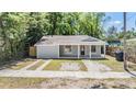 Cozy single-story house with a covered front porch and side driveway at 805 E Elm St, Tampa, FL 33604