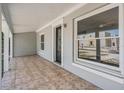 Inviting front porch featuring tiled flooring, a decorative front door, and ample natural light at 805 E Elm St, Tampa, FL 33604