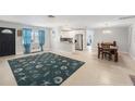 Open living room with tile floors, a ceiling fan and view of the kitchen and dining area at 831 72Nd N Ave, St Petersburg, FL 33702