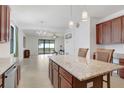 Open kitchen featuring a center island, granite countertops, and stainless steel appliances at 1214 Florablu Dr, Seffner, FL 33584