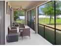 Relaxing screened-in patio with seating provides a tranquil outdoor space overlooking the manicured lawn at 1214 Florablu Dr, Seffner, FL 33584