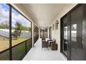 Relaxing screened patio with stylish seating and view of the backyard at 1214 Florablu Dr, Seffner, FL 33584