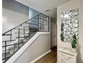 Staircase featuring modern railing and an eye-catching mirror to complement the aesthetic of the home at 12432 81St Ct, Seminole, FL 33772