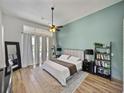 Serene main bedroom featuring modern decor, soft lighting, and tranquil backyard views through large windows at 1292 Myers Rd, Brooksville, FL 34602