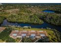 Aerial view of condo building showcasing waterfront living with convenient boat docks and lush landscape at 1686 Seascape Cir, Tarpon Springs, FL 34689