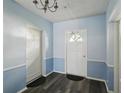Condo entryway with two-tone paint and updated flooring, offers a modern and clean look at 1705 Belleair Forest Dr # B, Belleair, FL 33756