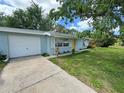 The exterior features a blue house with a yellow front door and a driveway at 1713 Valencia E Dr, Largo, FL 33778