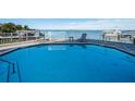Community pool overlooking a boat dock and serene water views, perfect for relaxation and waterfront living at 1860 N Fort Harrison Ave # 106, Clearwater, FL 33755
