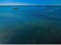Scenic waterfront shot with clear blue waters and distant islands, conveying a serene and expansive view at 1860 N Fort Harrison Ave # 106, Clearwater, FL 33755