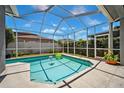 Inviting screened-in pool area with a sparkling pool and comfortable seating at 19750 Ellendale Dr, Land O Lakes, FL 34638