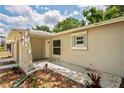 Home exterior featuring a stone accent and an archway entrance with a sidewalk and updated paint at 2207 Valleybrook Ave, Valrico, FL 33594