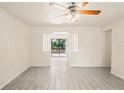 Bright living room showcasing modern tile flooring and an open design with natural light at 2207 Valleybrook Ave, Valrico, FL 33594