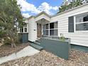 Charming front porch with a wood door, decorative ironwork, planter, and a welcoming entrance at 235 38Th S St, St Petersburg, FL 33711