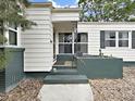 The front porch with a wood door and decorative ironwork offers a charming and inviting entrance at 235 38Th S St, St Petersburg, FL 33711