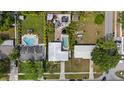 Aerial view of a home with a lush backyard, featuring a pool, jacuzzi, patio, and ample green space at 4003 W Bay Ave, Tampa, FL 33616