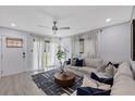 Bright living room with a modern ceiling fan, comfortable seating, and stylish decor at 4003 W Bay Ave, Tampa, FL 33616