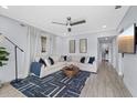Bright living room with a modern ceiling fan, comfortable seating, and stylish decor at 4003 W Bay Ave, Tampa, FL 33616