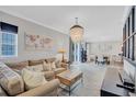 Cozy living room featuring a comfy sofa, a chandelier, and an open layout at 406 S Melville Ave # 1, Tampa, FL 33606