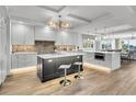 Bright modern kitchen featuring a large island, stainless steel appliances, and wood flooring at 455 Pinellas Bayway S # 2A, Tierra Verde, FL 33715