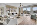 Cozy living room with comfortable seating, large windows, and water view at 455 Pinellas Bayway S # 2A, Tierra Verde, FL 33715