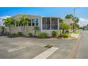 Well-maintained single-story home with lush landscaping, a screened porch, and covered parking at 4851 W Gandy Blvd # B09L23, Tampa, FL 33611