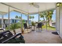 Relaxing screened-in porch featuring seating, a ceiling fan, and views of the surrounding community at 4851 W Gandy Blvd # B09L23, Tampa, FL 33611
