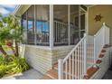 Inviting screened-in porch with a staircase and a cozy seating area and brick-style foundation at 4851 W Gandy Blvd # B09L23, Tampa, FL 33611