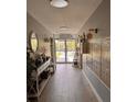Bright condo hallway with tile floors, mailboxes, and views of the outdoors at 5557 Sea Forest Dr # 216, New Port Richey, FL 34652