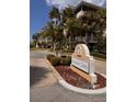Heather Cove condo complex sign with palm trees lining the entrance at 5557 Sea Forest Dr # 216, New Port Richey, FL 34652