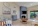 Inviting living room featuring high ceilings, fireplace, and sliding doors to a private balcony at 612 Fairmont Ave # D, Safety Harbor, FL 34695