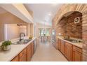 Spacious kitchen with brick accent and updated appliances overlooking the light-filled dining area at 6711 Thackston Dr, Riverview, FL 33578