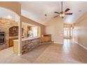 Open living room featuring tile floors, brick accents, and seamless flow to other living spaces at 6711 Thackston Dr, Riverview, FL 33578