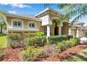 The exterior features a stucco finish, manicured landscaping, and architectural details adding to the curb appeal at 15714 Ibisridge Dr, Lithia, FL 33547