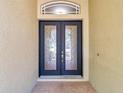 Elegant double front doors with decorative glass inserts and a brick paver landing enhance the entrance at 15714 Ibisridge Dr, Lithia, FL 33547