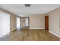 Spacious living room featuring hardwood floors, a front door, and neutral walls at 1881 Stancel Dr, Clearwater, FL 33764