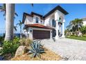 Beautiful residence boasting a tile roof, paver driveway, and manicured landscaping at 1901 Carolina Ne Ave, St Petersburg, FL 33703
