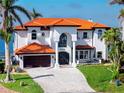 Elegant home featuring a tile roof, a double-door entrance, and well-manicured front yard at 1901 Carolina Ne Ave, St Petersburg, FL 33703