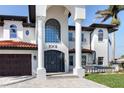 Grand entrance showcasing a tile roof, columns, and a striking double door at 1901 Carolina Ne Ave, St Petersburg, FL 33703