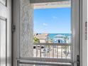 Relaxing ocean view from the condo balcony of neighboring beach houses at 19925 Gulf Blvd # 402, Indian Shores, FL 33785