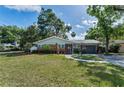Charming brick home with a landscaped yard and walkway at 202 S Hesperides St, Tampa, FL 33609