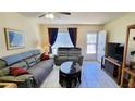 Cozy living room with sofas, tile floors, ceiling fan, and natural light at 2213 Fluorshire Dr, Brandon, FL 33511