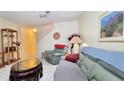 Comfortable living room with sofas, tile floors, and staircase in the background at 2213 Fluorshire Dr, Brandon, FL 33511